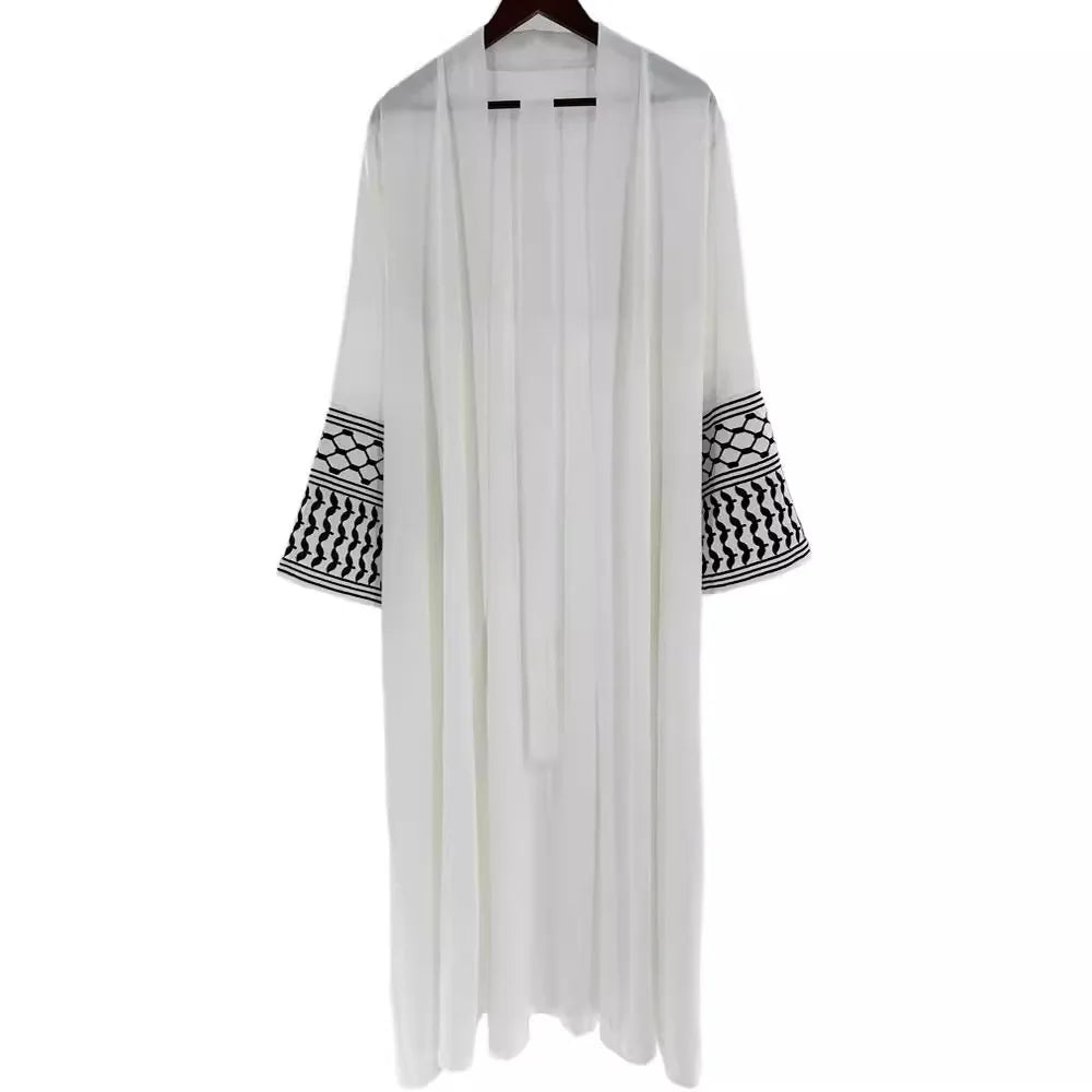 Kuffiyeh-inspired abaya with embroidered sleeves and detachable belt.