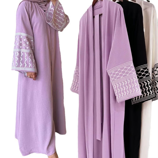 Kuffiyeh-inspired abaya with embroidered sleeves and detachable belt.